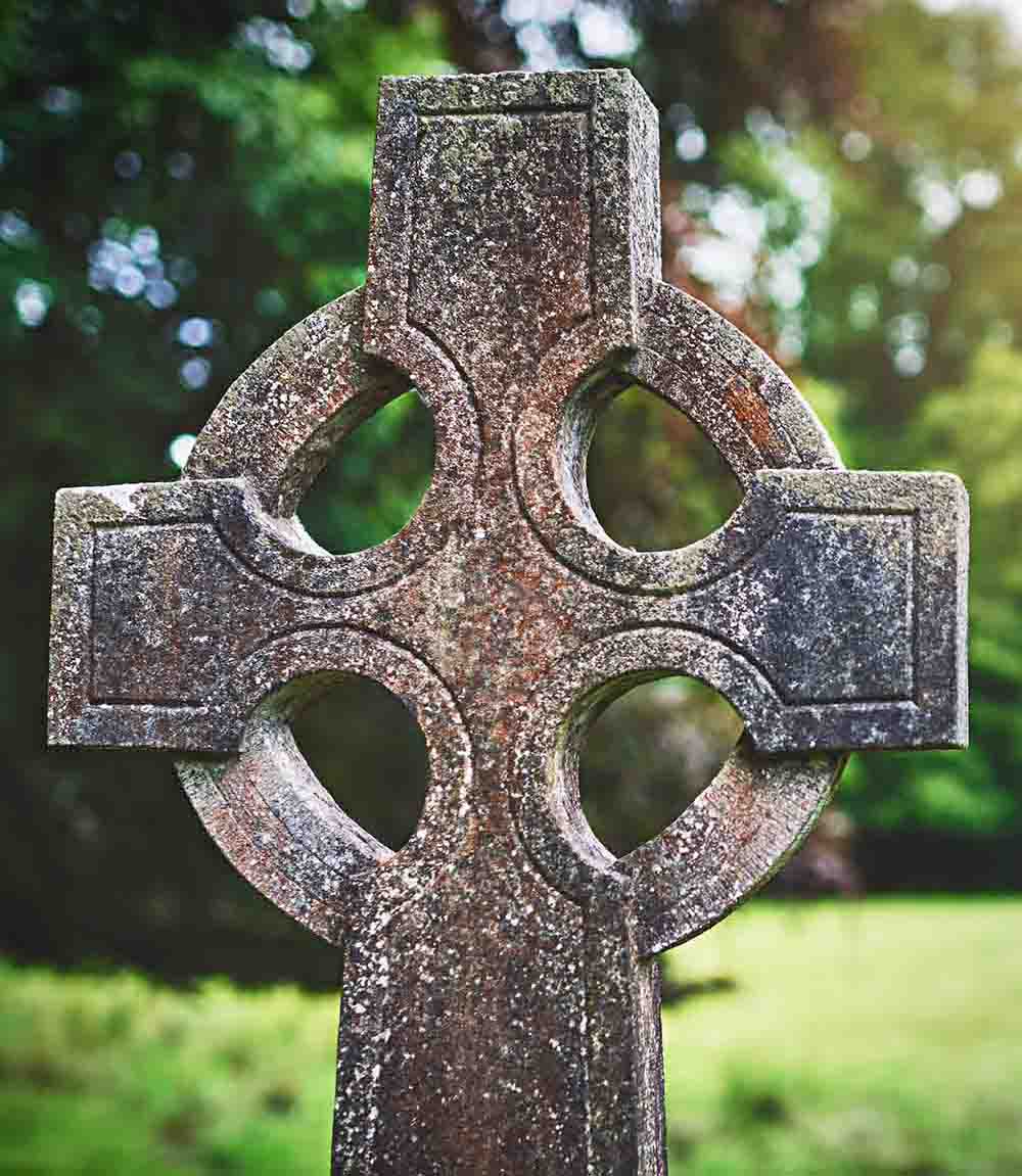 Laid to rest under the cross. Shot of a gravestone in a cemetery